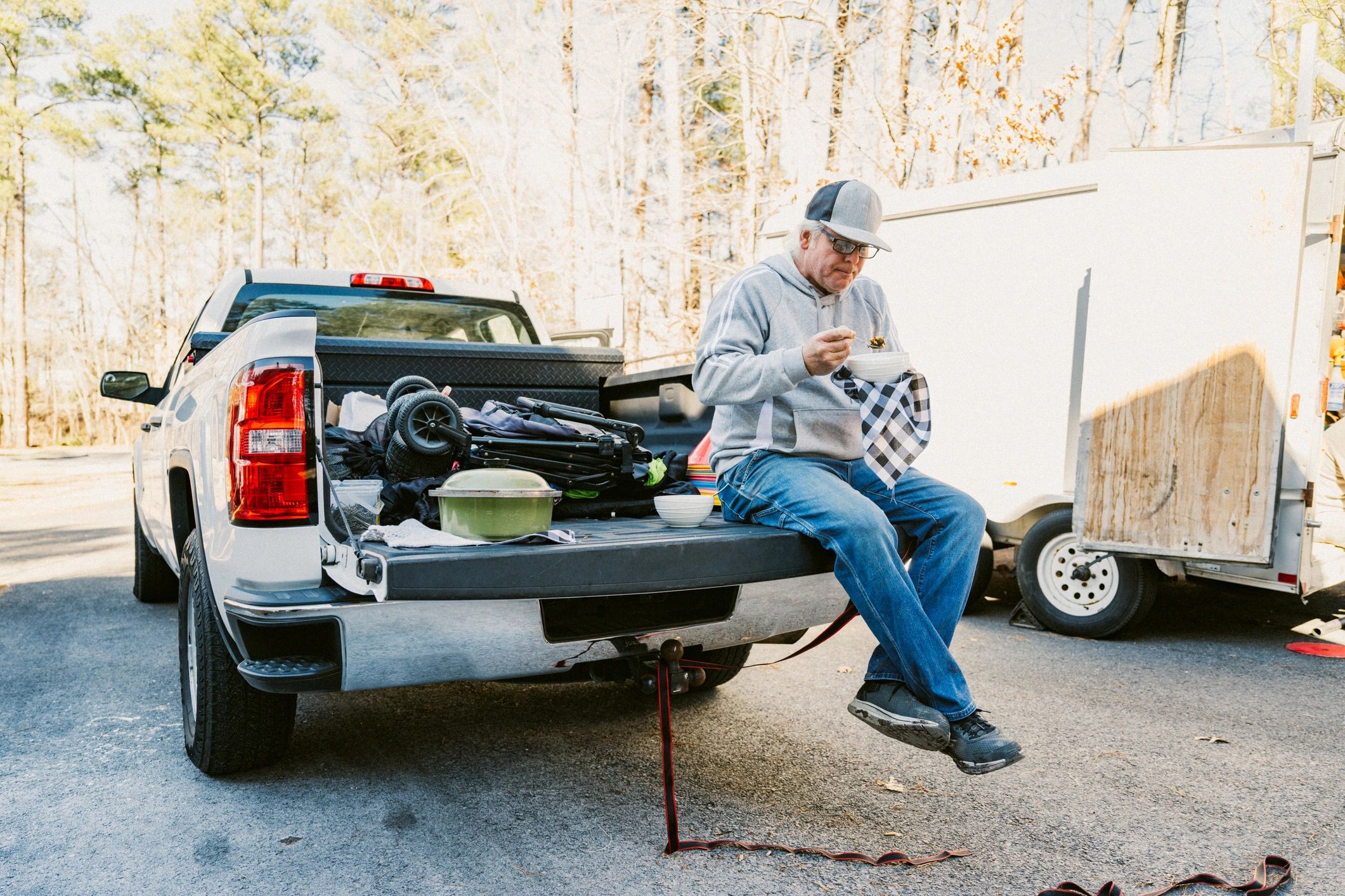 Mobile technician taking a break beside a work truck